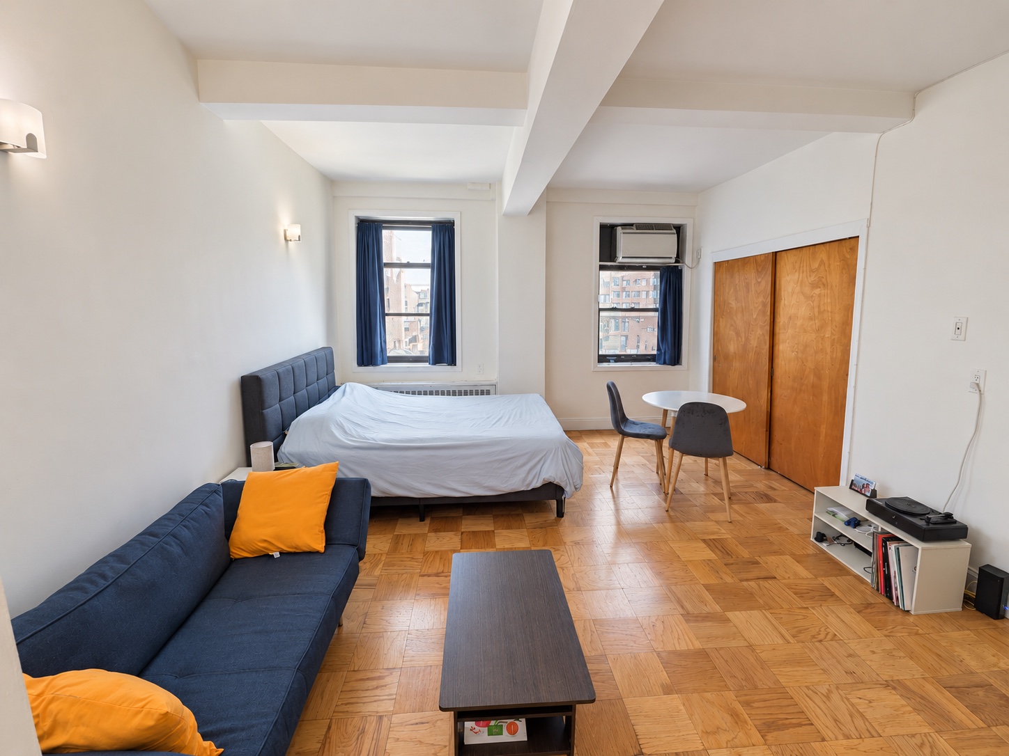 Bright daytime view of the studio living and sleeping area at 132 East 45th Street